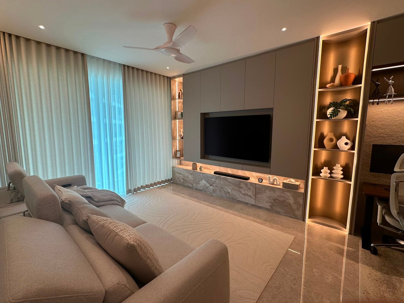 Living and dining room after turnkey renovation with custom marble finishes and integrated brass cove lighting